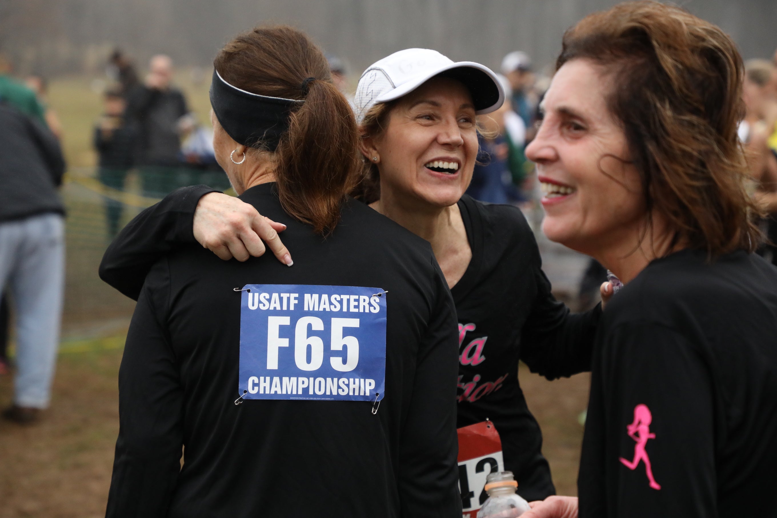 The Bella N Motion masters team, based in New Jersey, celebrates at the finish line of the 2019 USATF Club Cross Country Championships.