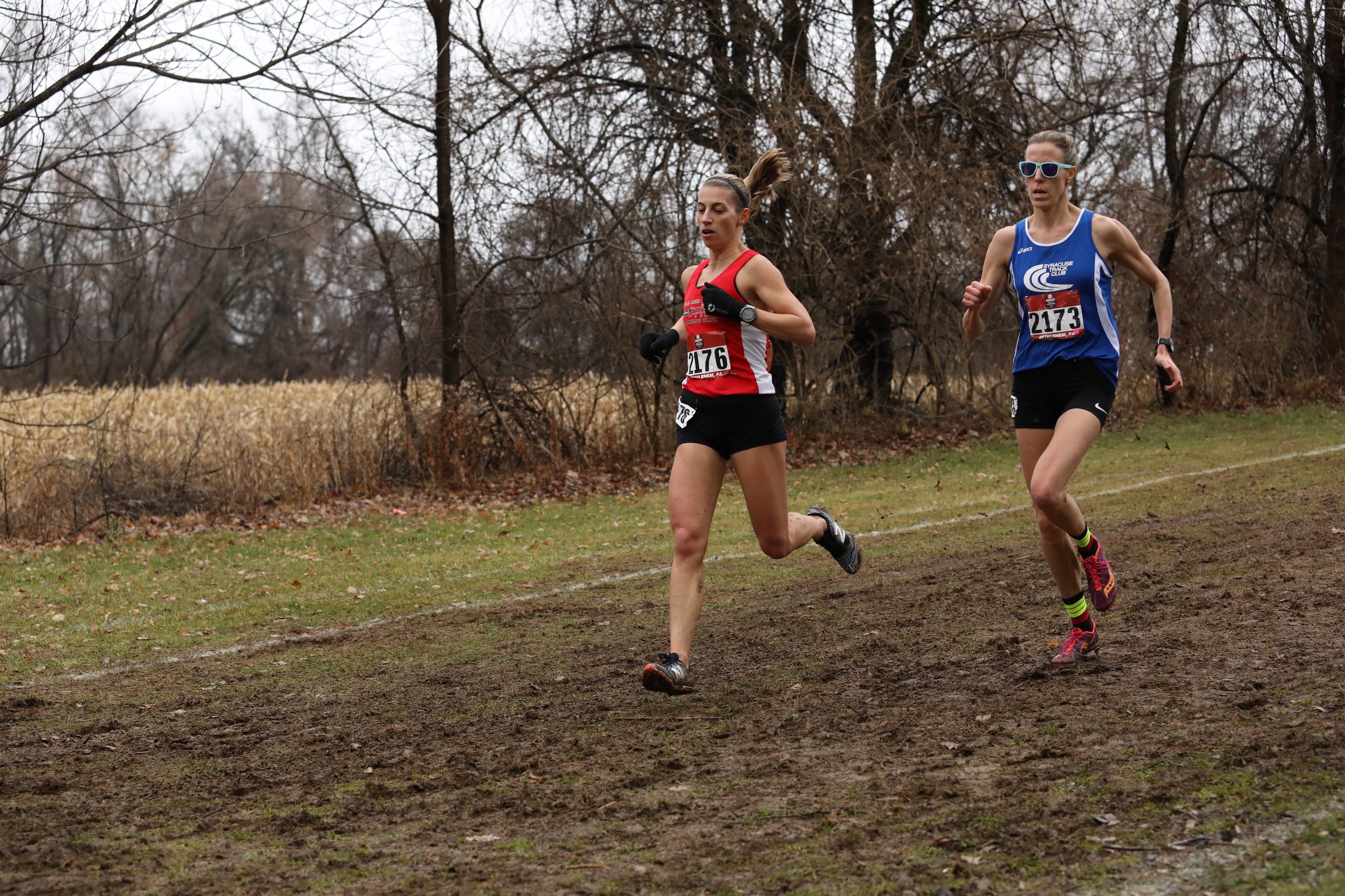 Eventual 2019 USATF Club Cross Country Championships masters division winner Sascha Scott of Syracuse battles through the mud against Casey Hire, 40, from Team Red Lizard, who placed fourth.