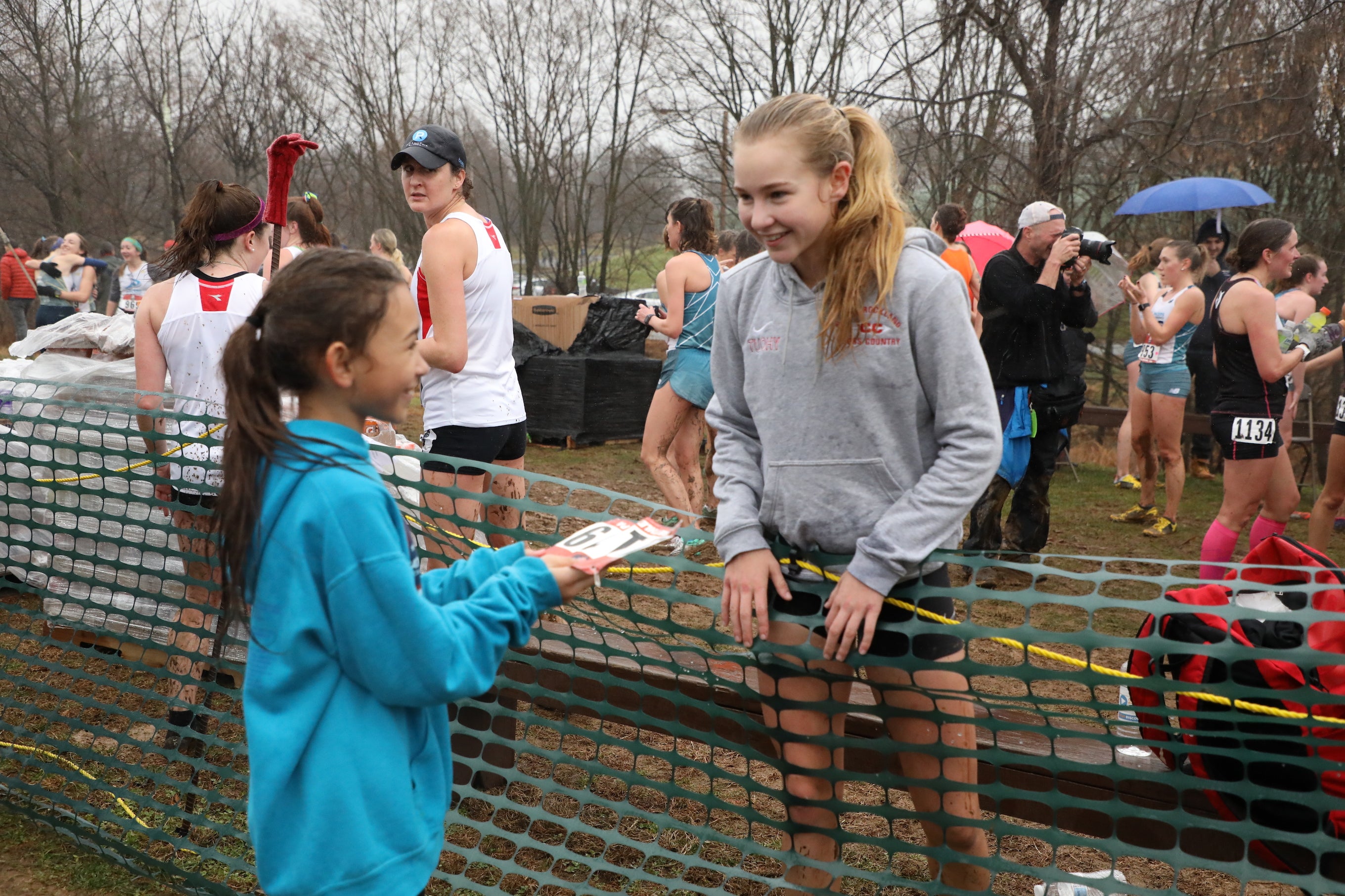 Katelyn Tuohy, 17, greets 10-year-old Paige Stoltz of Hershey, Pennsylvania. Tuohy, a high school senior, won the Nike Cross Nationals meet for the third time a week before racing the 2019 USATF Club Cross Country Championships, where she placed second in her first competition against pro runners.