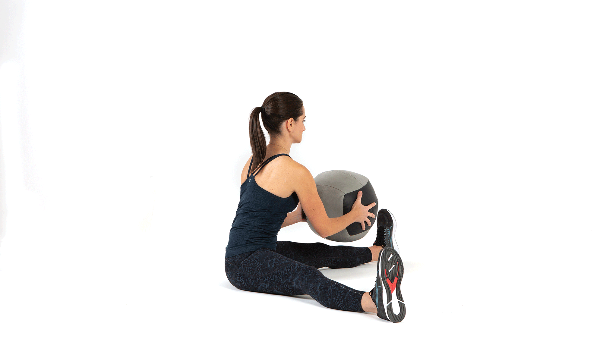 Animation of woman sitting on floor with legs spread, twisting and throwing ball behind her