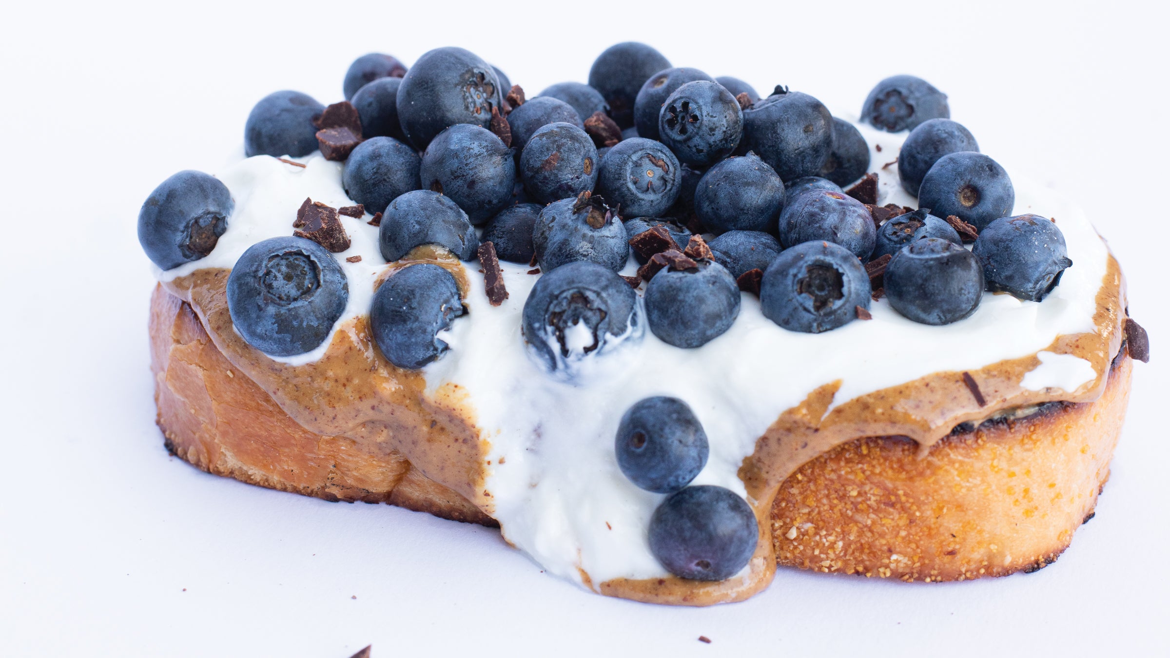 Toast with almond butter, greek yogurt, and blueberries