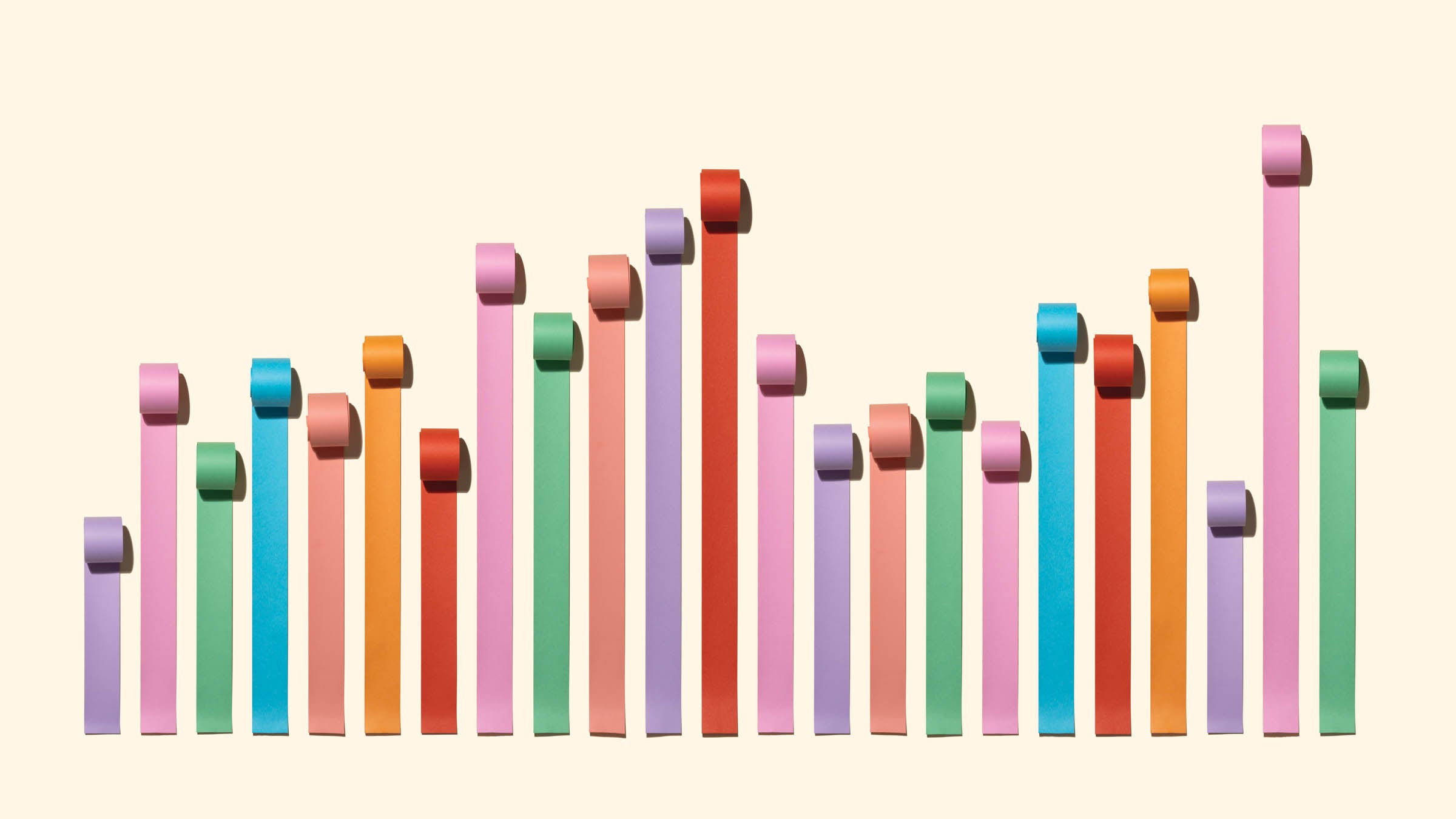 Chaos Bar Chart Made of Paper Rolls on Solid Beige Background.