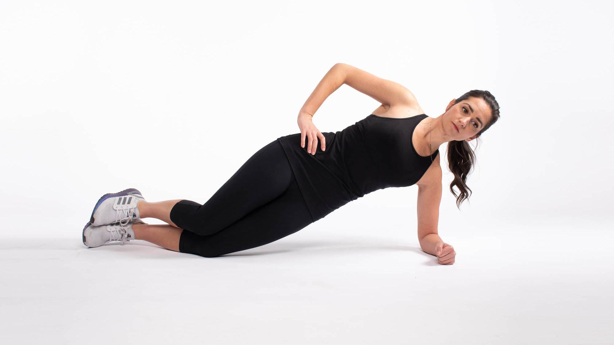Woman doing side plank with knees on the floor