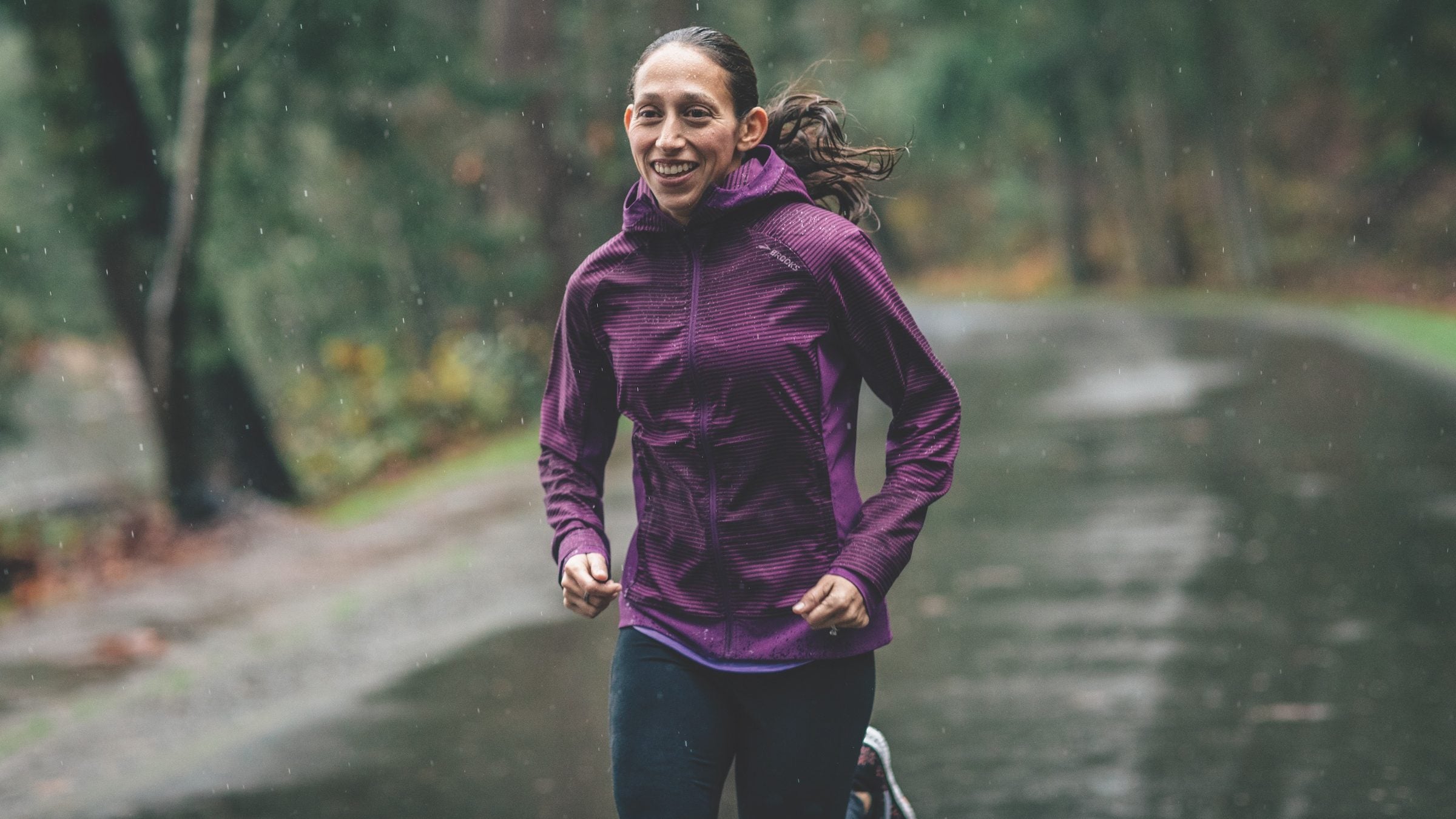 Desiree Linden running on a rainy road