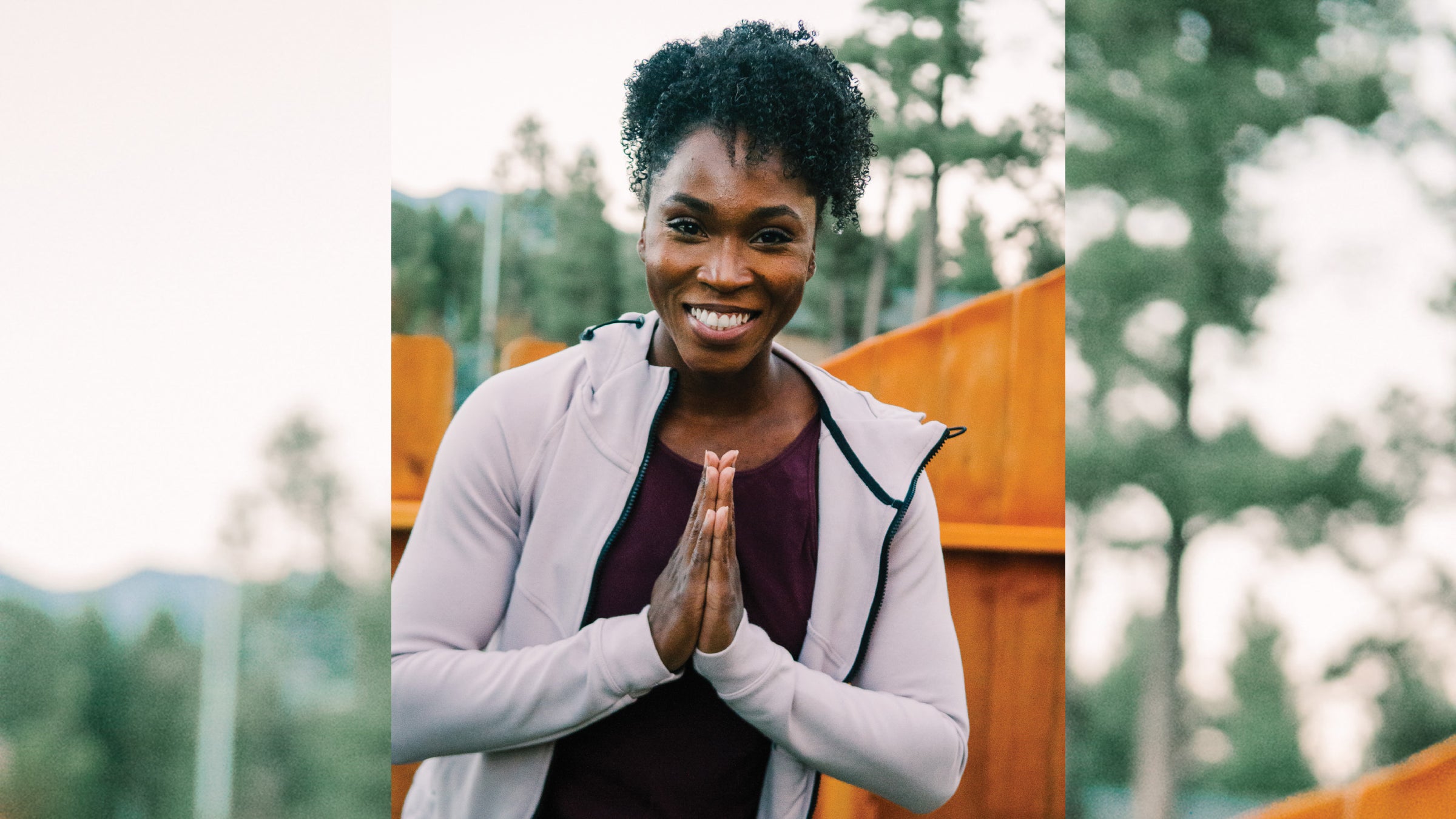 Tianna Bartoletta poses with her hands in prayer pose